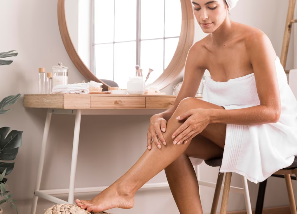 Woman moisturising legs image